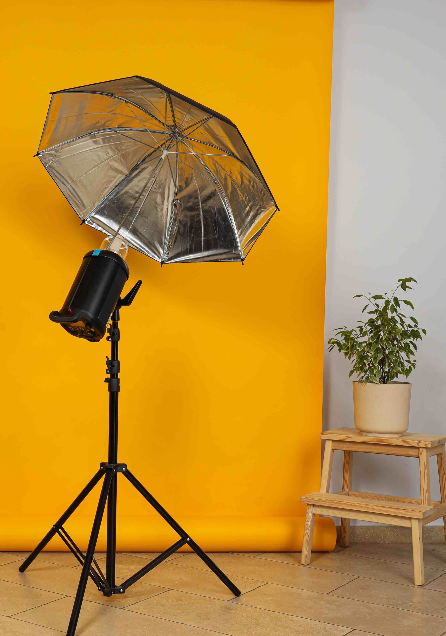 Photo studio and its interior components, yellow background and flash